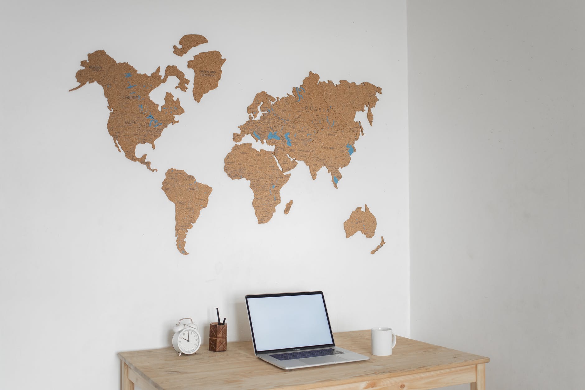 laptop near wall with world map