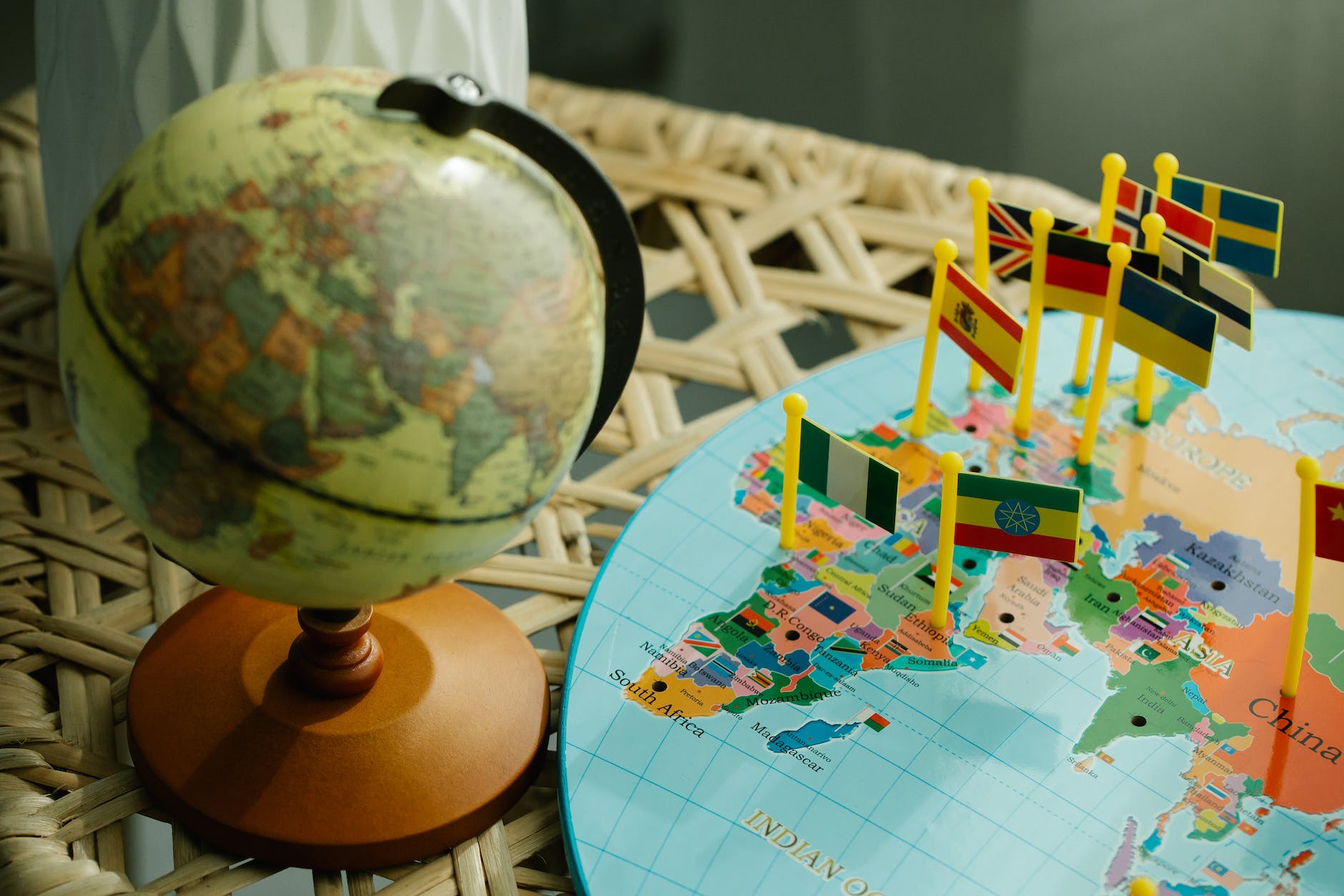 globe and a flat world map with country flag markers
